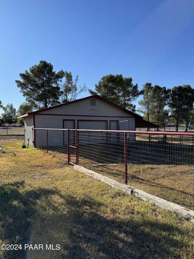 view of outbuilding featuring a yard and a garage