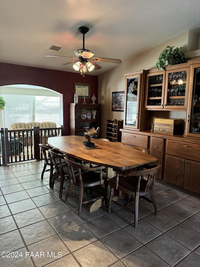 dining space with tile patterned floors and ceiling fan