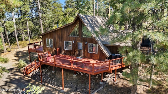 rear view of house with a wooden deck