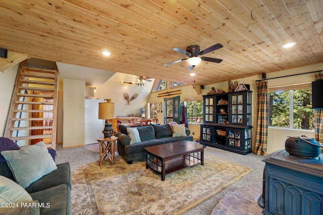 living room with a wood stove, light carpet, ceiling fan, and wood ceiling