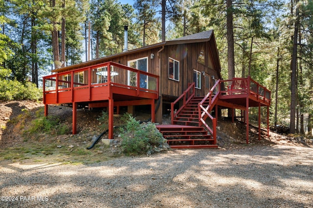 rear view of property featuring a wooden deck