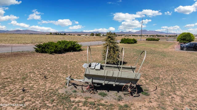 view of yard with a rural view and a mountain view