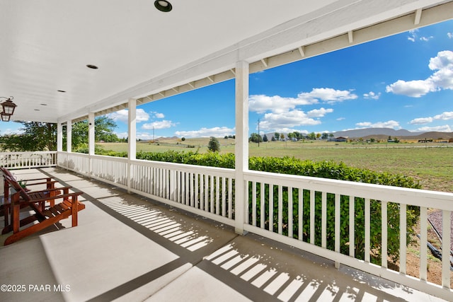 view of patio / terrace with a mountain view and a rural view