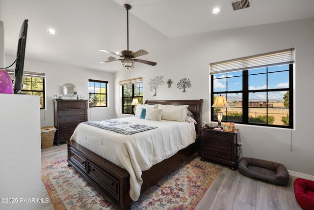bedroom with visible vents, a ceiling fan, vaulted ceiling, light wood-style floors, and recessed lighting