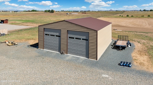 detached garage with a rural view