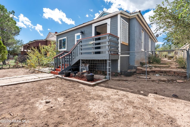 rear view of house with a wooden deck