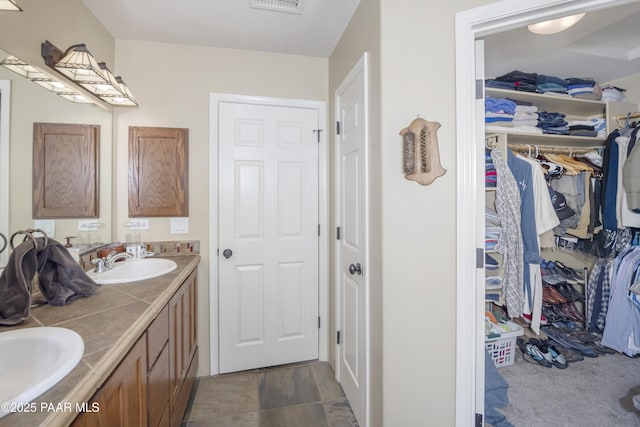 1101 S Milton Ave, Prescott, AZ 86303 - full bathroom featuring double vanity, a spacious closet, and stone finish flooring