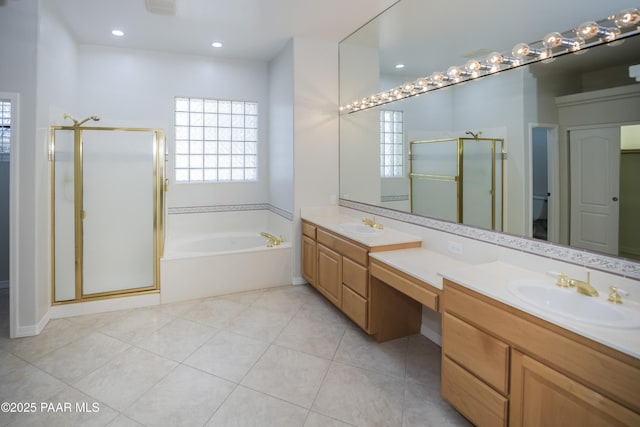 bathroom featuring double vanity, a sink, a garden tub, and a stall shower
