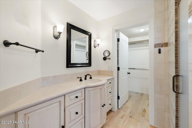 full bathroom featuring vanity and wood finished floors