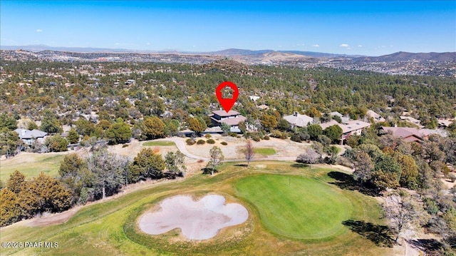 aerial view featuring view of golf course and a mountain view