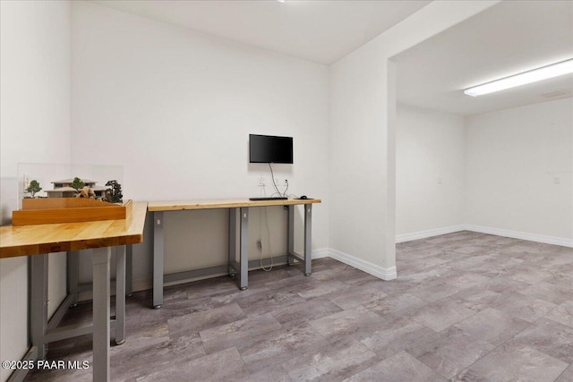 unfurnished office with baseboards