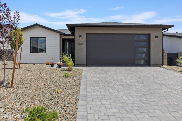 5083 N Kingsley Ct, Prescott Valley, AZ 86314 - view of front of home featuring decorative driveway, an attached garage, and stucco siding