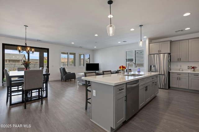 5083 N Kingsley Ct, Prescott Valley, AZ 86314 - kitchen featuring stainless steel appliances, gray cabinetry, light countertops, a kitchen breakfast bar, and recessed lighting