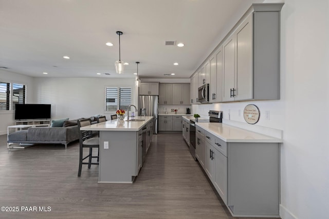 5083 N Kingsley Ct, Prescott Valley, AZ 86314 - kitchen with appliances with stainless steel finishes, gray cabinets, open floor plan, healthy amount of natural light, and recessed lighting