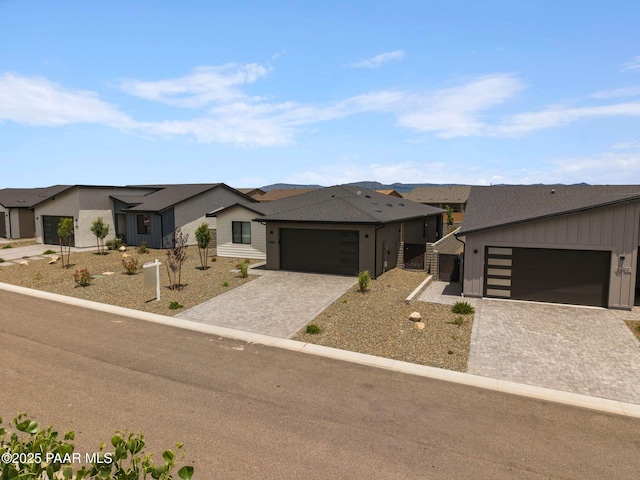 5083 N Kingsley Ct, Prescott Valley, AZ 86314 - view of front of home with a garage, decorative driveway, a residential view, and board and batten siding