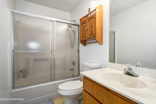 full bathroom with combined bath / shower with glass door, vanity, and toilet