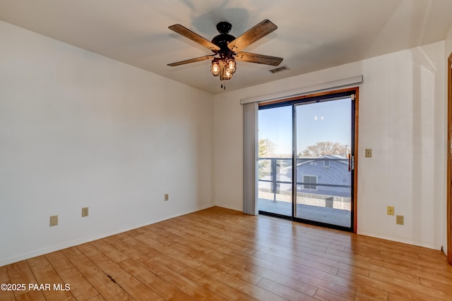 unfurnished room featuring light wood-type flooring, ceiling fan, visible vents, and baseboards