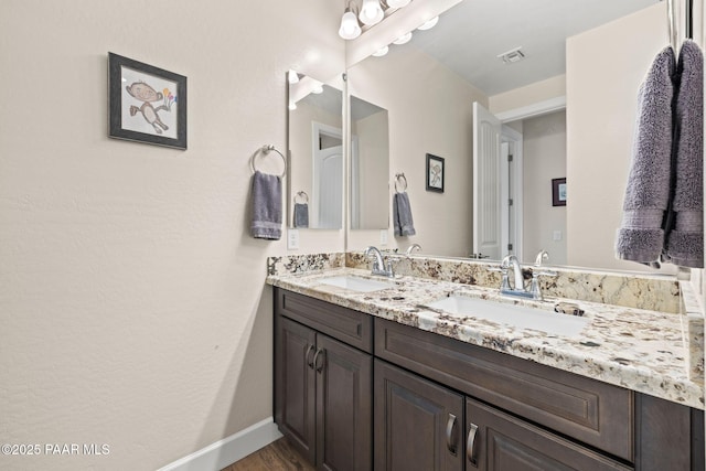 1450 Henry Dr, Chino Valley, AZ 86323 - full bathroom featuring double vanity, wood finished floors, and baseboards