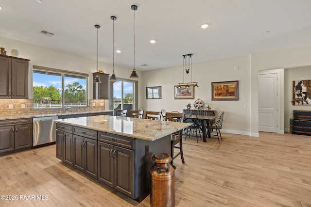 1450 Henry Dr, Chino Valley, AZ 86323 - kitchen featuring stainless steel dishwasher, a breakfast bar, tasteful backsplash, a center island, and recessed lighting