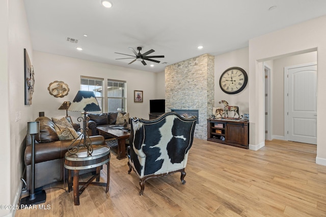 1450 Henry Dr, Chino Valley, AZ 86323 - living area with ceiling fan, light wood finished floors, recessed lighting, a stone fireplace, and baseboards