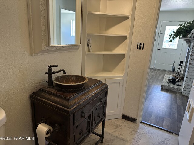 2532 Huron St, Dewey-Humboldt, AZ 86329 - bathroom featuring a textured wall, vanity, built in features, and marble look tile flooring