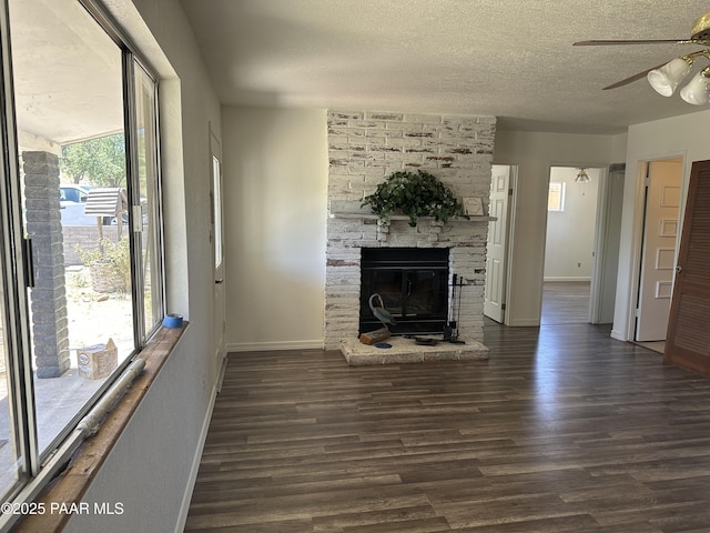 2532 Huron St, Dewey-Humboldt, AZ 86329 - unfurnished living room featuring ceiling fan, a textured ceiling, wood finished floors, and a fireplace