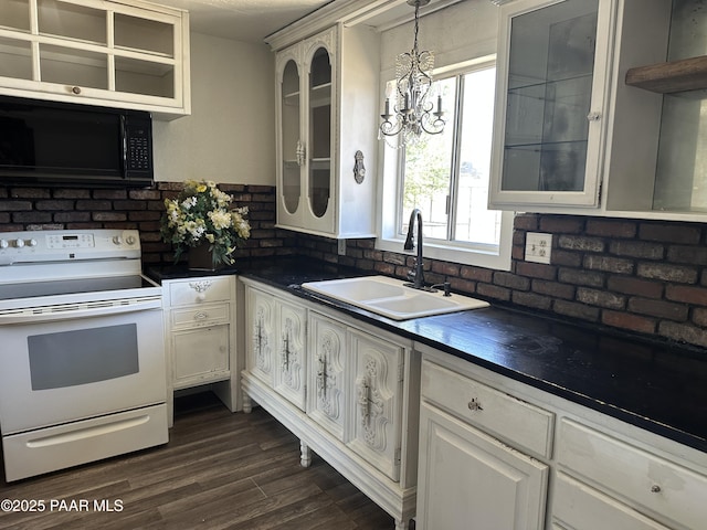 2532 Huron St, Dewey-Humboldt, AZ 86329 - kitchen featuring electric range, black microwave, dark countertops, glass insert cabinets, and a chandelier