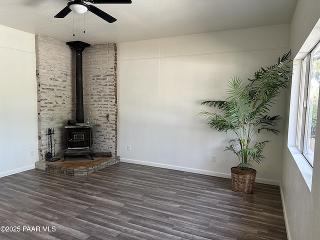 2532 Huron St, Dewey-Humboldt, AZ 86329 - unfurnished living room featuring a wood stove, wood finished floors, a ceiling fan, and a textured ceiling