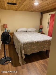 bedroom with hardwood / wood-style flooring and wooden ceiling