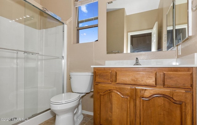 bathroom with walk in shower, tile patterned floors, vanity, and toilet