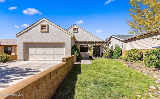 view of front of property with a front yard and a garage