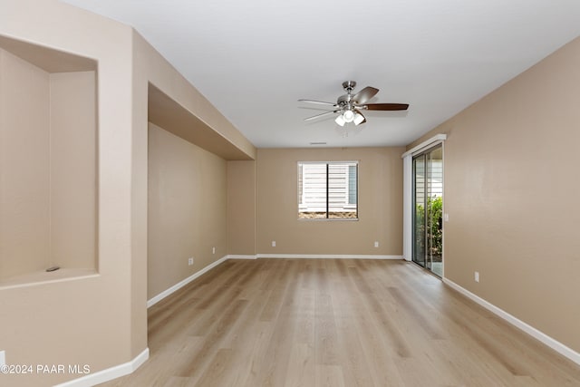 spare room featuring ceiling fan and light hardwood / wood-style flooring