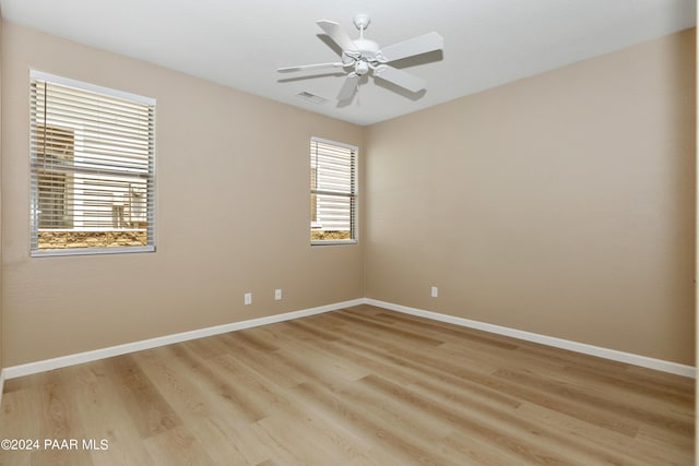 spare room featuring light hardwood / wood-style flooring and ceiling fan