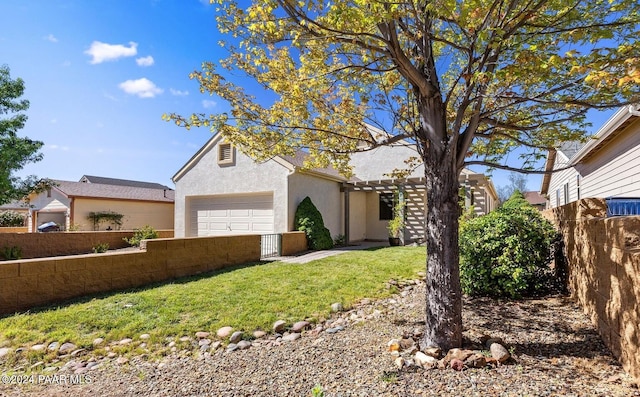 view of front of home with a garage and a front yard