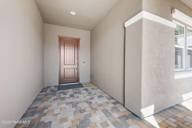 entrance to property featuring stucco siding