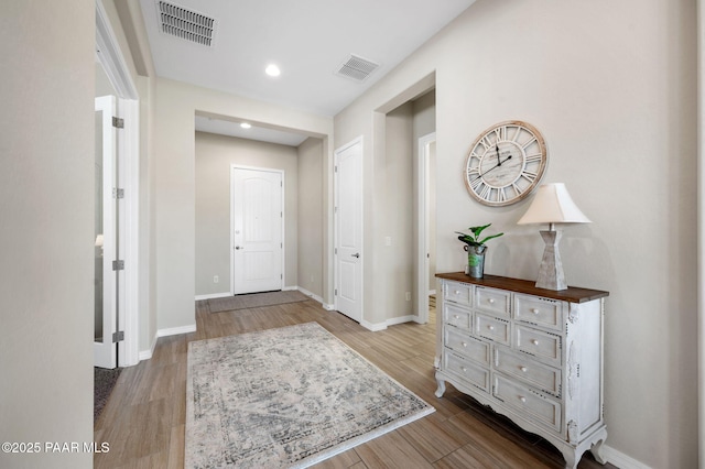 foyer featuring recessed lighting, wood finished floors, visible vents, and baseboards