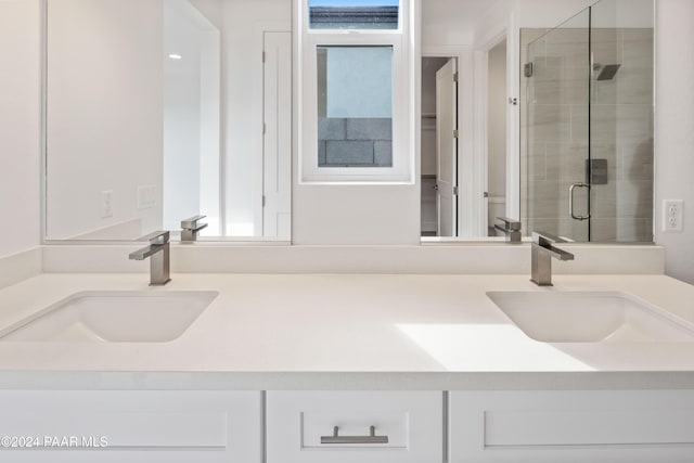 bathroom featuring vanity, toilet, and a shower with shower door