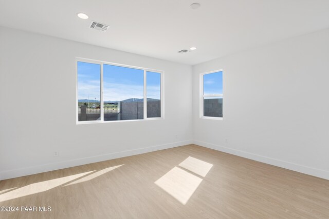 spare room with light hardwood / wood-style flooring