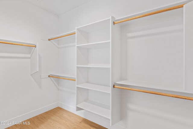 walk in closet featuring hardwood / wood-style flooring