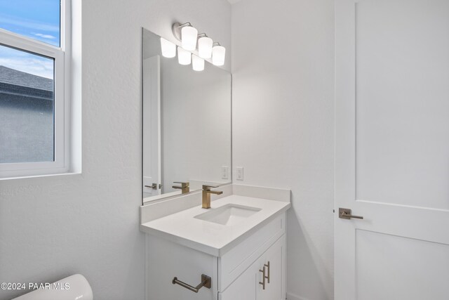 bathroom featuring vanity and toilet