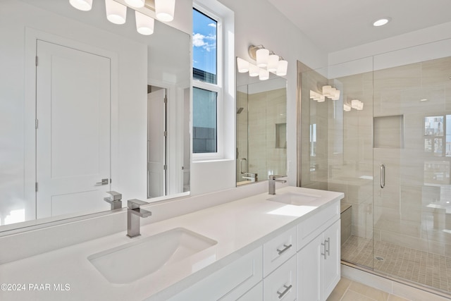 bathroom featuring tile patterned flooring, vanity, and a shower with shower door