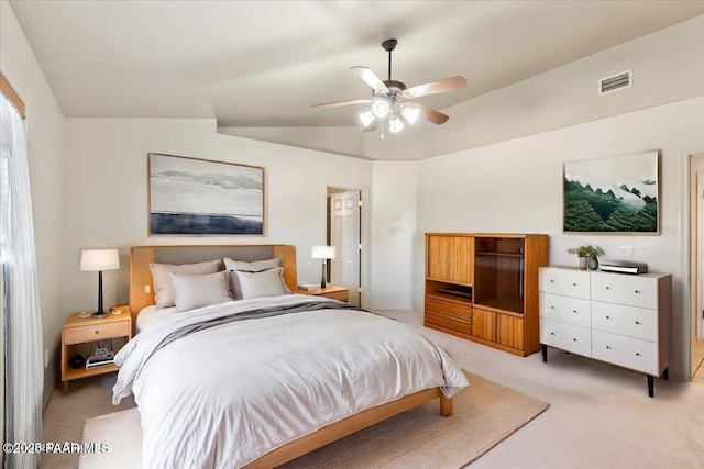 bedroom with vaulted ceiling, light carpet, and ceiling fan