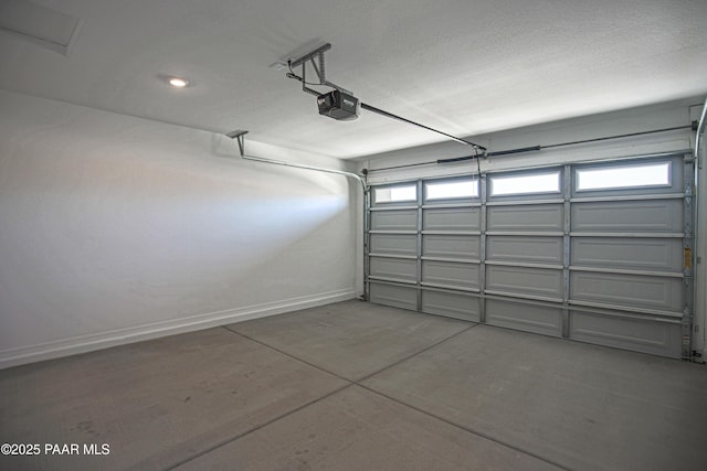 garage with baseboards and a garage door opener
