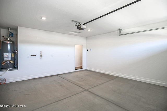 garage with recessed lighting, baseboards, a garage door opener, and gas water heater