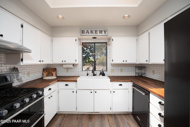 17571 E Hummingbird Ln, Mayer, AZ 86333 - kitchen with wooden counters, double oven range, dishwashing machine, a sink, and under cabinet range hood