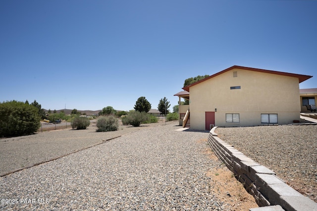 17571 E Hummingbird Ln, Mayer, AZ 86333 - view of home's exterior featuring stairway and stucco siding