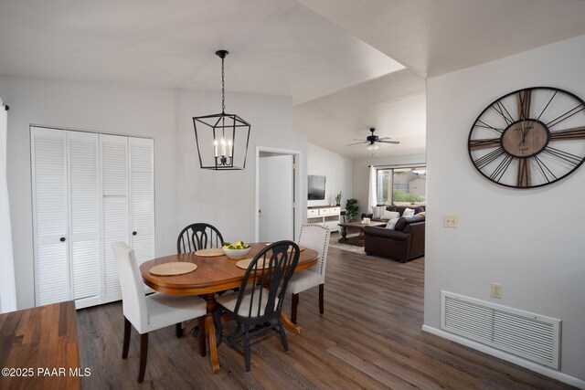 17571 E Hummingbird Ln, Mayer, AZ 86333 - dining room with dark wood-type flooring, ceiling fan, a chandelier, and vaulted ceiling