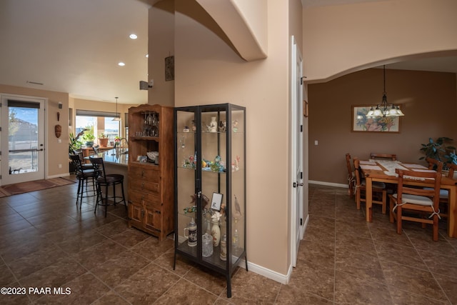 interior space featuring high vaulted ceiling and dark tile patterned floors