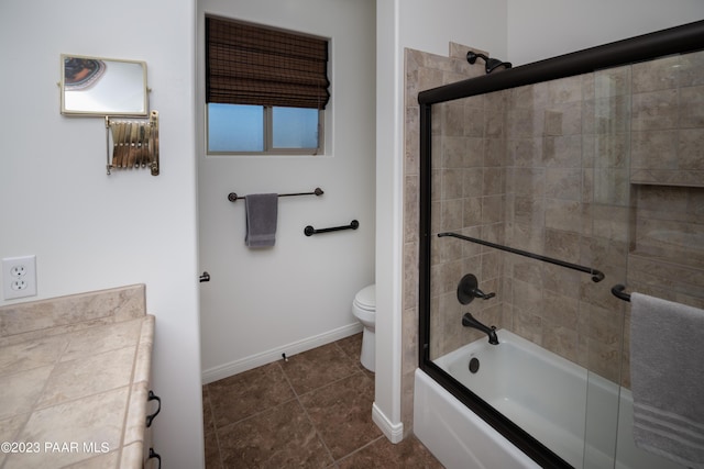 bathroom featuring tile patterned floors, toilet, and enclosed tub / shower combo