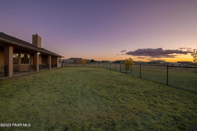 view of yard at dusk